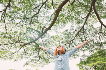Young beautiful asian women stretch enjoying with fresh air in t