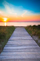 Wall murals Descent to the beach Wooden beach path to sand and sea at sunset