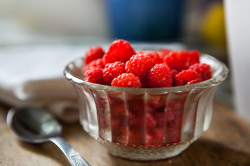 Raspberry Fruits in the kitchen prepared to eat in a ball on a woodn plate