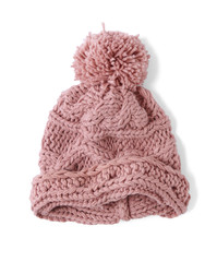A cable knit winter beanie with pom pom, isolated on a white background