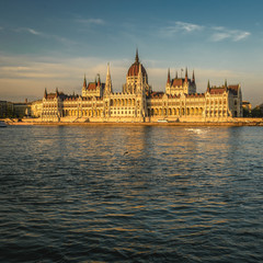 Hungarian Parliament Building in Budapest along Danube River at sunset.