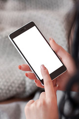 Empty screen of smartphone in womans hands. Female hands touching mobile phone with white screen copyspace. Free space for content on moboie phone screen in female hands