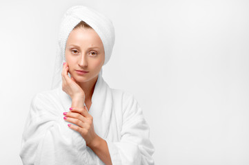 Beauty portrait of woman wearing a towel and white bathrobe