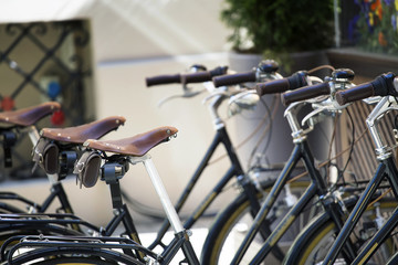Fototapeta na wymiar Parked old bicycles on the street of the European city.