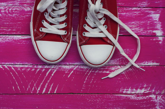  pair of red sneakers with white laces