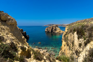 Fototapeta na wymiar Gozo coastline Rocky coastline of Gozo between Mgarr and Hondoq bay with crystal clear waters