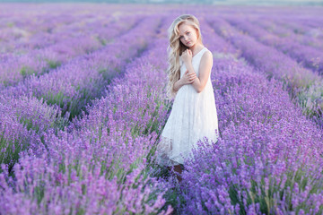 Beautiful small blond girl on the lavender field