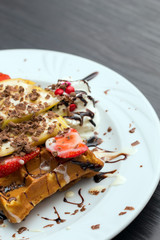 Belgian waffles with ice cream, chocolate and strawberries