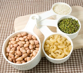 Pasta, Rice, Peanuts and Mung Beans in Measuring Spoons