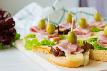 Canapes with ham, cheese and salad