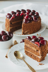 Piece of chocolate layer cake with black cherry vertical