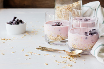 Obraz na płótnie Canvas Glasses of yoghurt with oatmeal