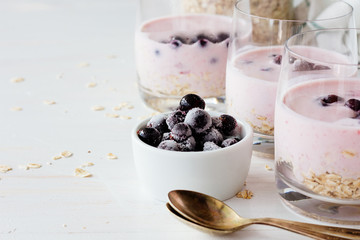 Frozen berries and glasses with yoghurt
