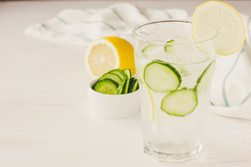Cold drink with cucumber and lemon copy space