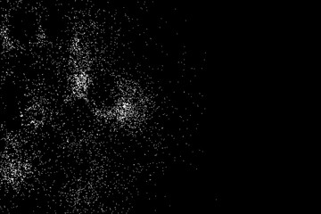 Abstract grainy texture isolated on black background. Silhouette of food flakes such as salt or almond or wheat flour spread on the flat surface or table. Top view. Dust, sand blow or bread crumbs.
