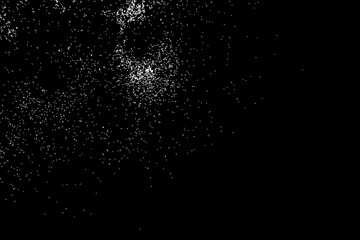 Abstract grainy texture isolated on black background. Silhouette of food flakes such as salt or almond or wheat flour spread on the flat surface or table. Top view. Dust, sand blow or bread crumbs.