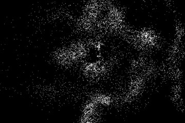 Abstract grainy texture isolated on black background. Silhouette of food flakes such as salt or almond or wheat flour spread on the flat surface or table. Top view. Dust, sand blow or bread crumbs.