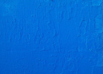 Fragment of old wall painted over in blue color.