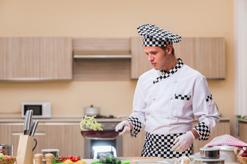 Male cook preparing food in the kitchen