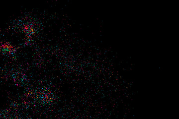 Colorful explosion of confetti. Isolated on black background. Coloured glitter and sprinkles. Grainy abstract holiday illustration. Multi colored texture.