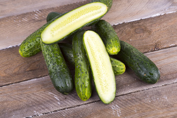 green cucumber on old boards