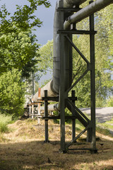 metal pipes with the construction of the road and trees
