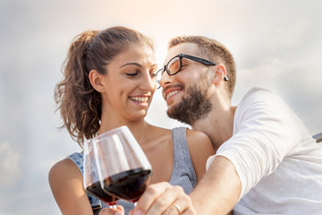 young couple farmers toasts in their vineyard