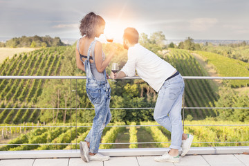 young couple toasting in a vineyard at sunrise