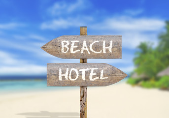 Wooden direction sign on beach or hotel
