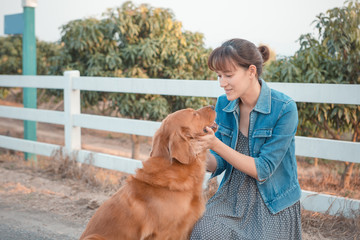 Beautiful woman with a cute golden retriever dog