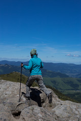 Summer hiking in the mountains with a backpack and tent.