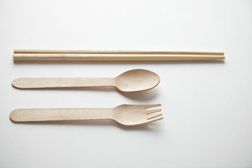 Mixed of kitchen utencils for takeaway: asian chopsticks, spoon or fork made from recycled paper or wood, eco friendly, top view presented top view on white