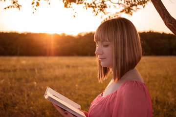 Girl with a book on nature