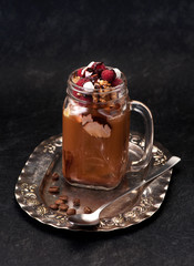 iced coffee with chocolate ice cream and raspberries on vintage plate