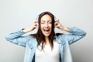 Young beautiful woman listening music with headphones