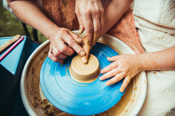 child working on potter's wheel