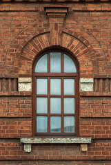 Window with an arch on the background wall of brown brick. From the series window of Saint-Petersburg.