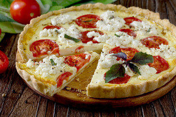 The classic quiche Lorraine pie with soft feta cheese, basil and