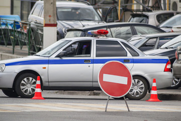 A police car blocked the road and put up signs prohibiting travel.