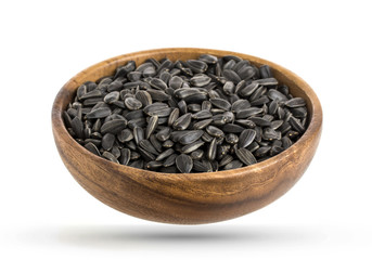 Wood bowl of black sunflower seeds isolated on white background