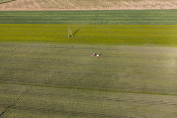 aerial view of the tractor on harvest field