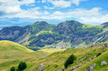 Naklejka premium Montenegro, national park Durmitor, mountains and clouds. Sunlight lanscape.