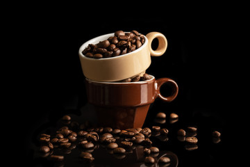 Two cups with coffee seeds