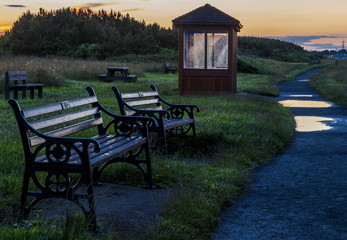 Seaside Wooden Shelter and bench seats at Cambois Beach on the coast of Northumberland, England,...