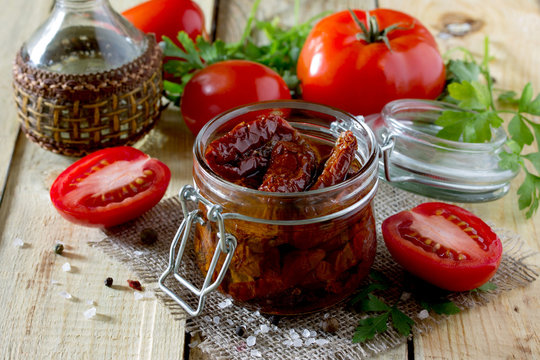 Sun dried tomatoes on a wooden table in rustic style