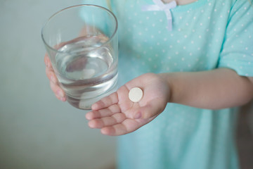 medicine tablet in the hands of a child