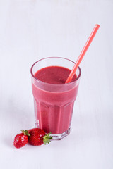 Glass with strawberry cocktail on the table