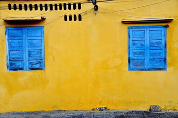 blue window and yellow wall at Hoi An in Vietnam
