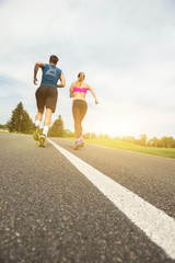 Cheerful couple competing in jogging