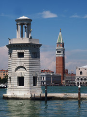 Venice, Italy - Unusual view of St. Marc Square with Doge's Palace and St. Marc belltower from St. George Island, with a lighthouse tower